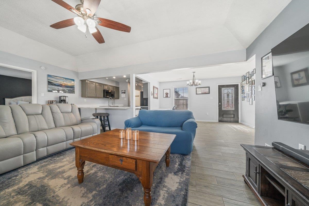6310 Prairie View Drive Bartlett, TN 38134 - Photo 13 of 27 Living area with light wood-style floors, ceiling fan, hanging lights, and vaulted ceiling