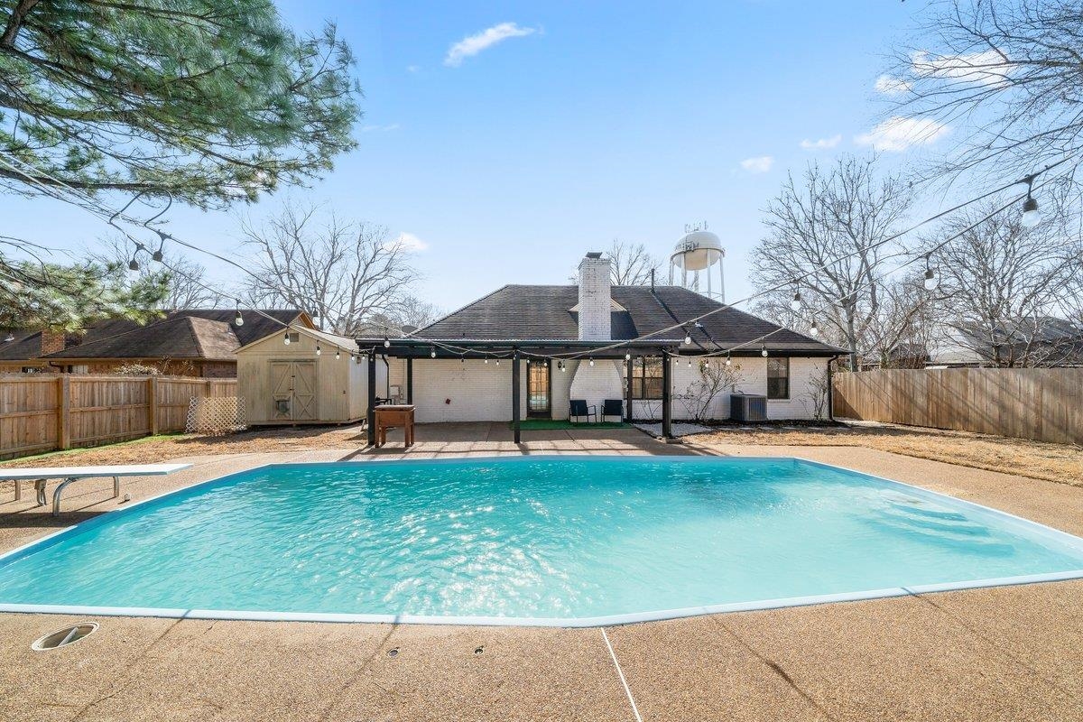 6310 Prairie View Drive Bartlett, TN 38134 - Photo 26 of 27 View of pool featuring patio surround, a fenced backyard, and a storage unit