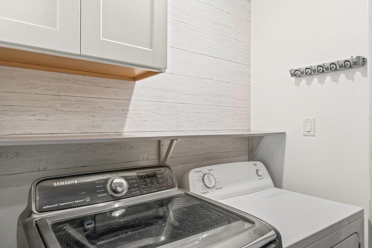 6310 Prairie View Drive Bartlett, TN 38134 - Photo 6 of 27 Laundry area with washing machine and clothes dryer and wood walls