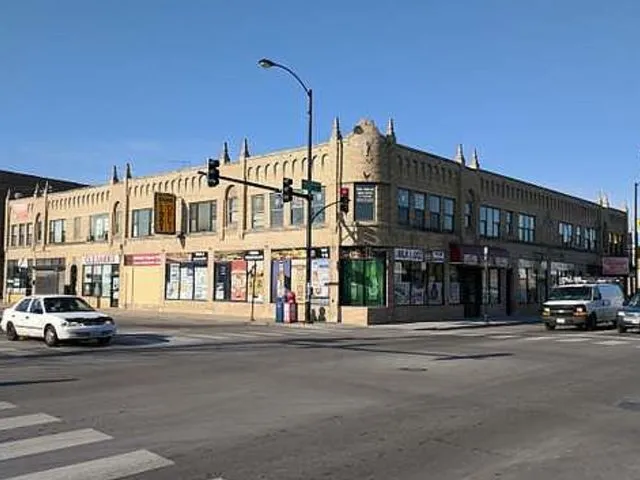 a city street lined with buildings and cars parked