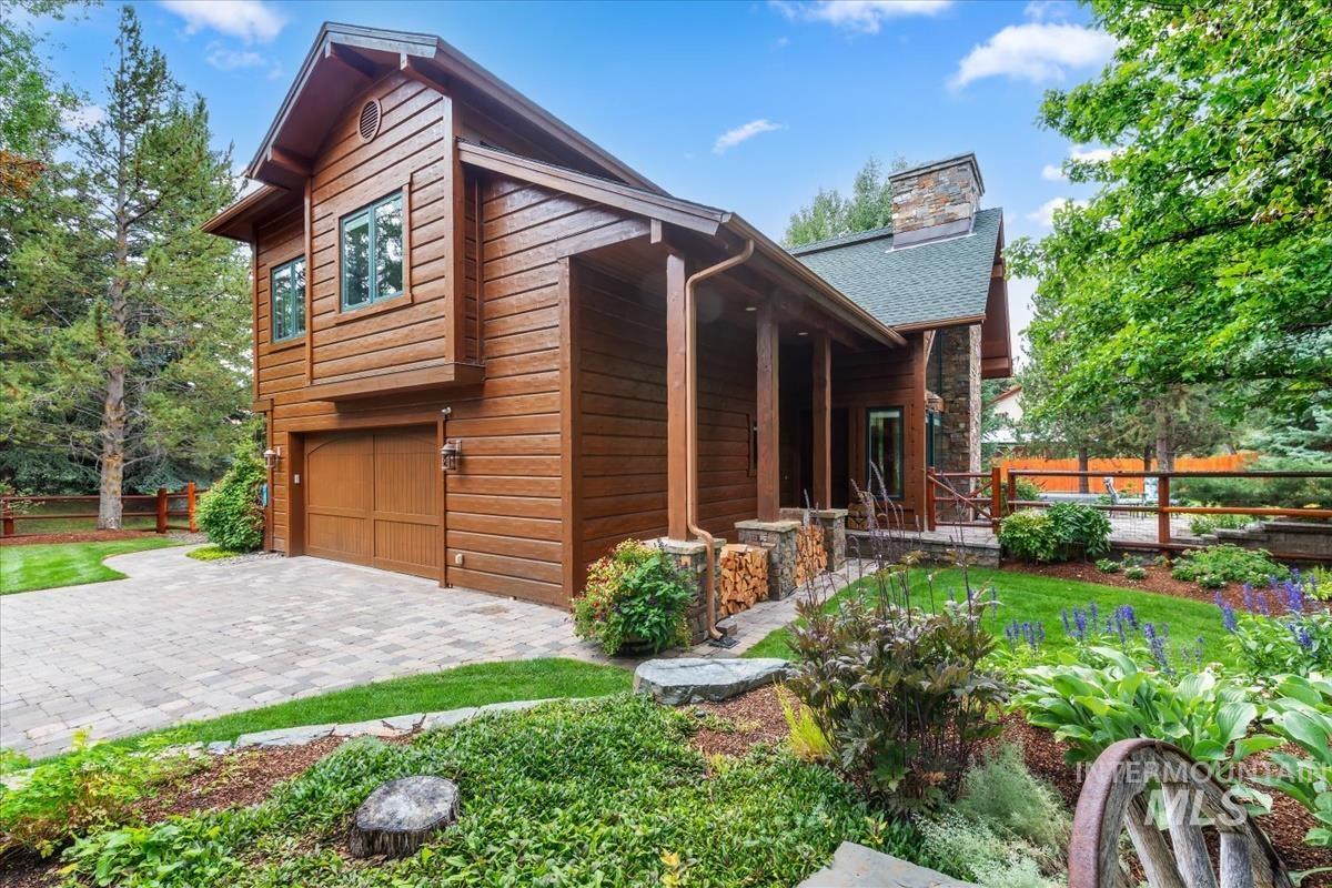 106 Hidden Hollow Road Hailey, ID 83333 - Photo 4 of 49 Wood-sided exterior with a stone chimney and a covered porch