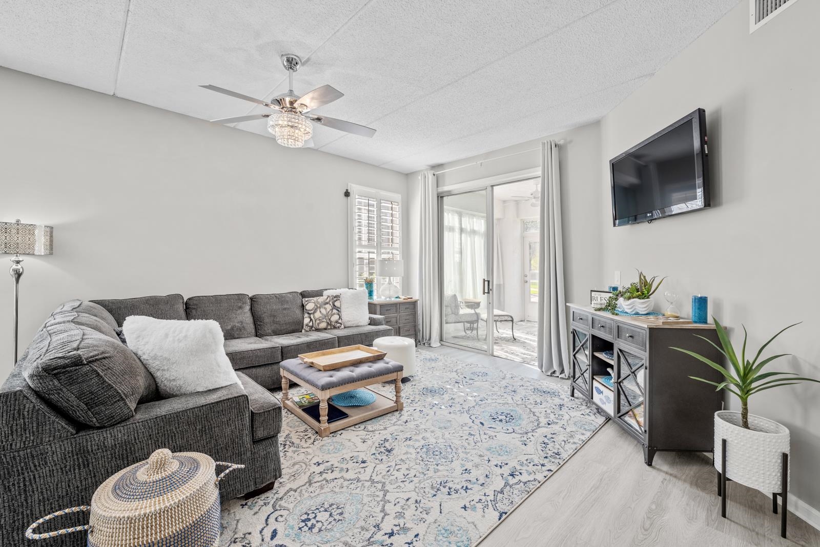 500 Augusta Circle St. Augustine, FL 32086 - Photo 13 of 39 a living room with furniture a flat screen tv and a window