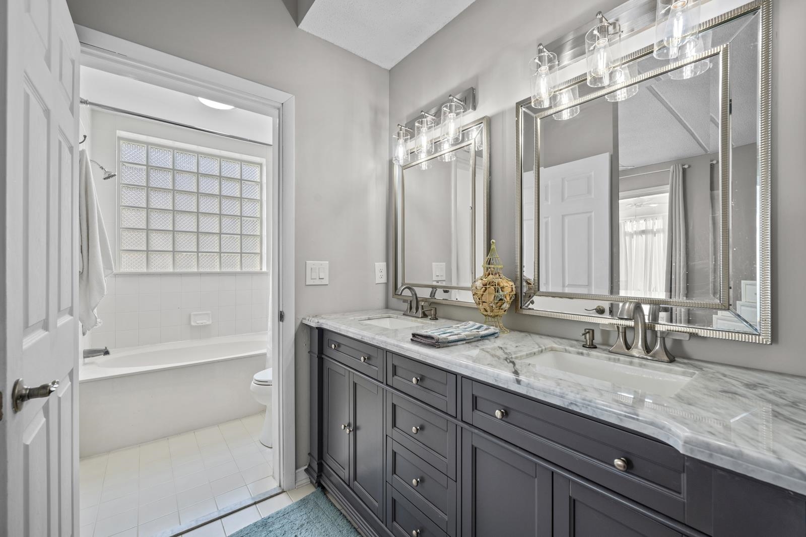 500 Augusta Circle St. Augustine, FL 32086 - Photo 19 of 39 a bathroom with double vanity and a mirror
