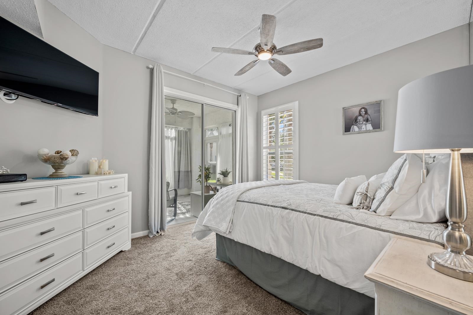 500 Augusta Circle St. Augustine, FL 32086 - Photo 20 of 39 a bedroom with a bed a window and a flat screen television