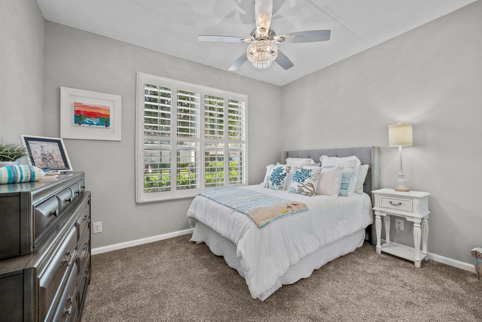 500 Augusta Circle St. Augustine, FL 32086 - Photo 21 of 39 a spacious bedroom with a bed and a chandelier