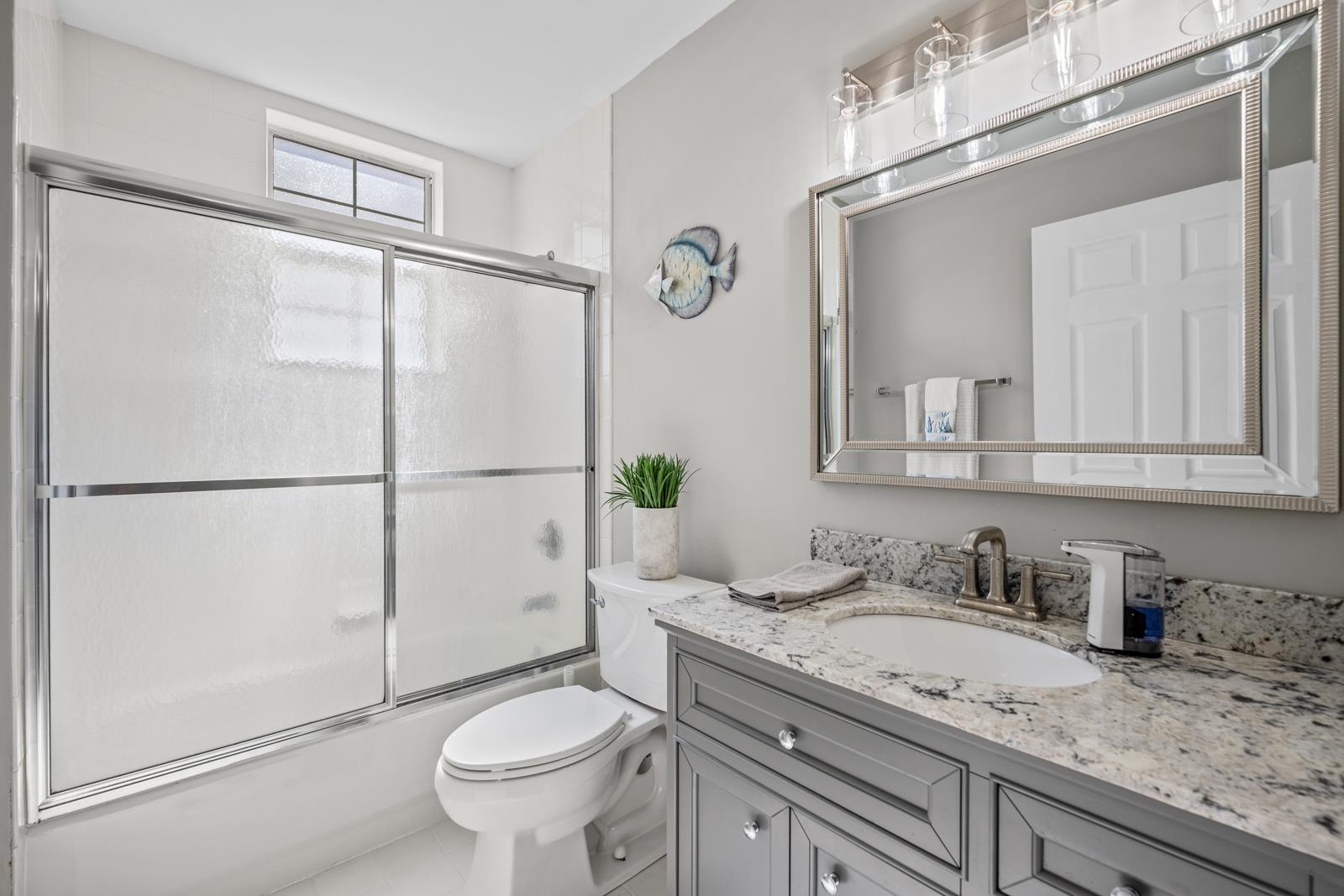 500 Augusta Circle St. Augustine, FL 32086 - Photo 22 of 39 a bathroom with a granite countertop sink toilet and shower