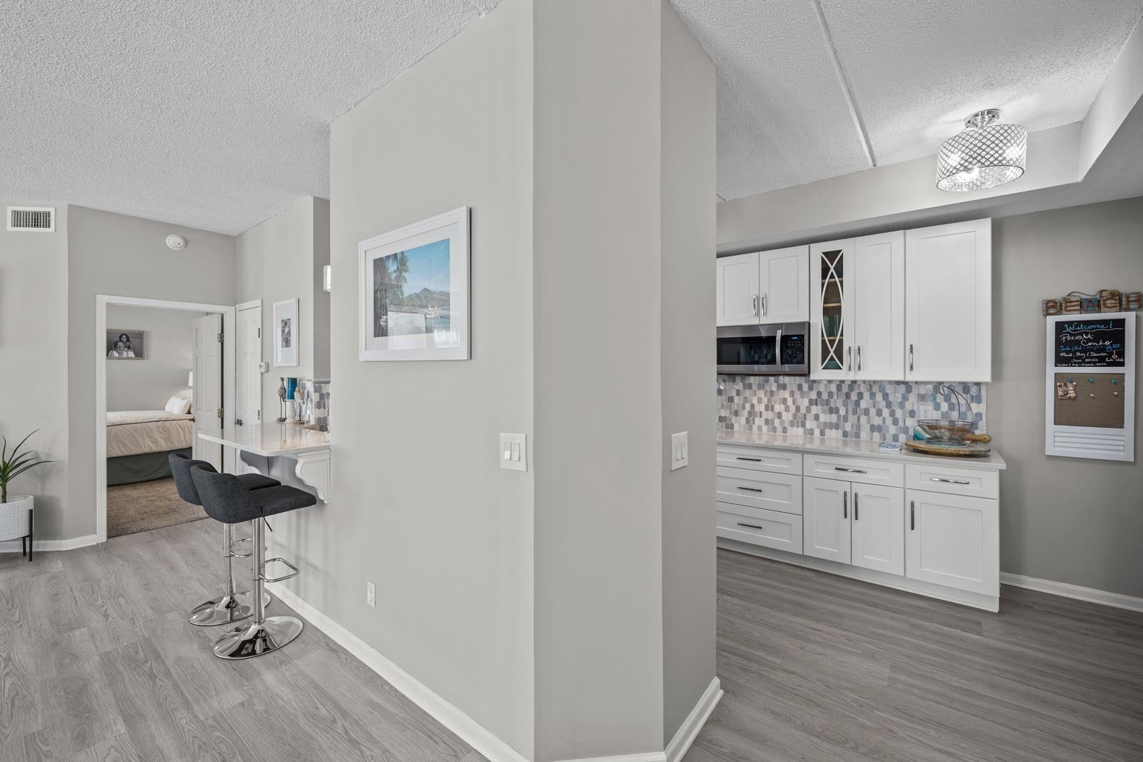 500 Augusta Circle St. Augustine, FL 32086 - Photo 4 of 39 a kitchen with kitchen island a sink cabinets and wooden floor
