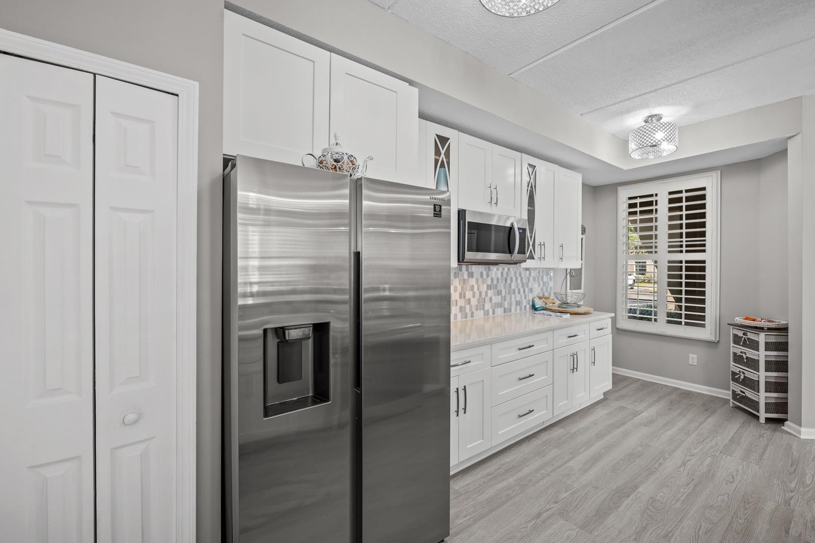 500 Augusta Circle St. Augustine, FL 32086 - Photo 7 of 39 a kitchen with stainless steel appliances a refrigerator and cabinets