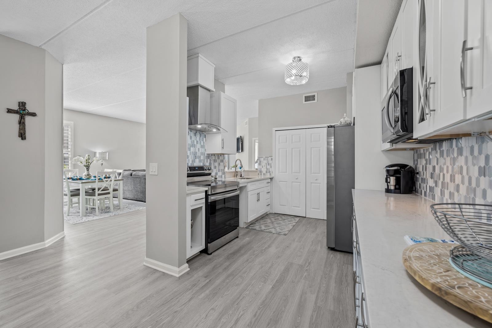 500 Augusta Circle St. Augustine, FL 32086 - Photo 8 of 39 a kitchen with stainless steel appliances a refrigerator a stove a sink and white cabinets