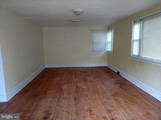 6173 Bethlehem Road Preston, MD 21655 - Photo 3 of 8 wooden floor in an empty room with a window