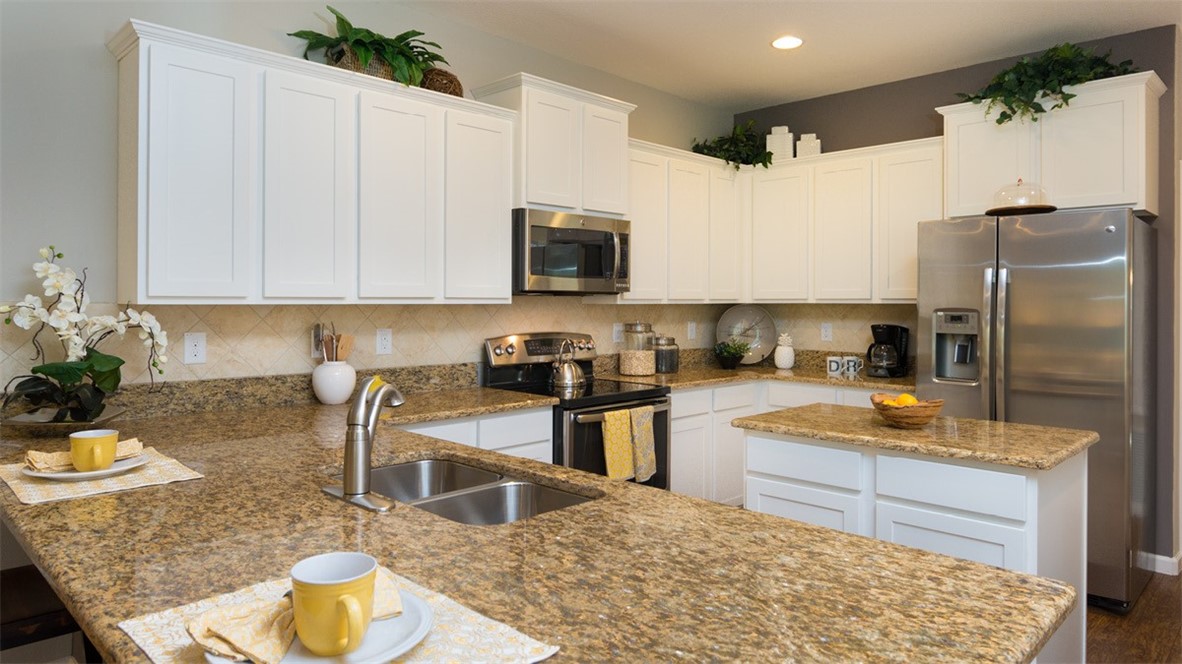 94 52nd Square Vero Beach, FL 32968 - Photo 9 of 20 a kitchen with stainless steel appliances granite countertop a sink refrigerator and cabinets