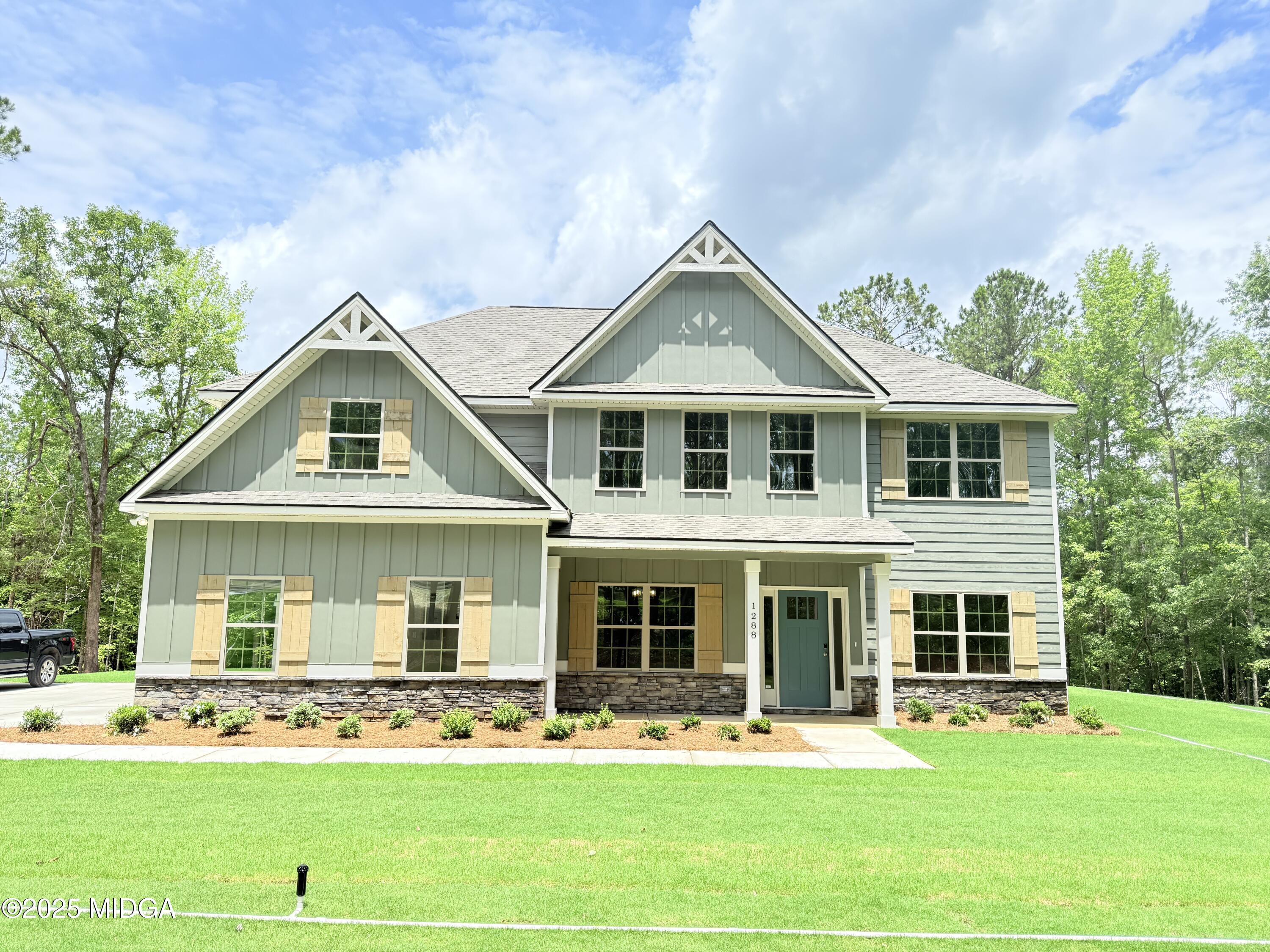 1288 Teagle Road, Unit 9 Forsyth, GA 31029 - Photo 1 of 1 a front view of a house with a yard table and chairs