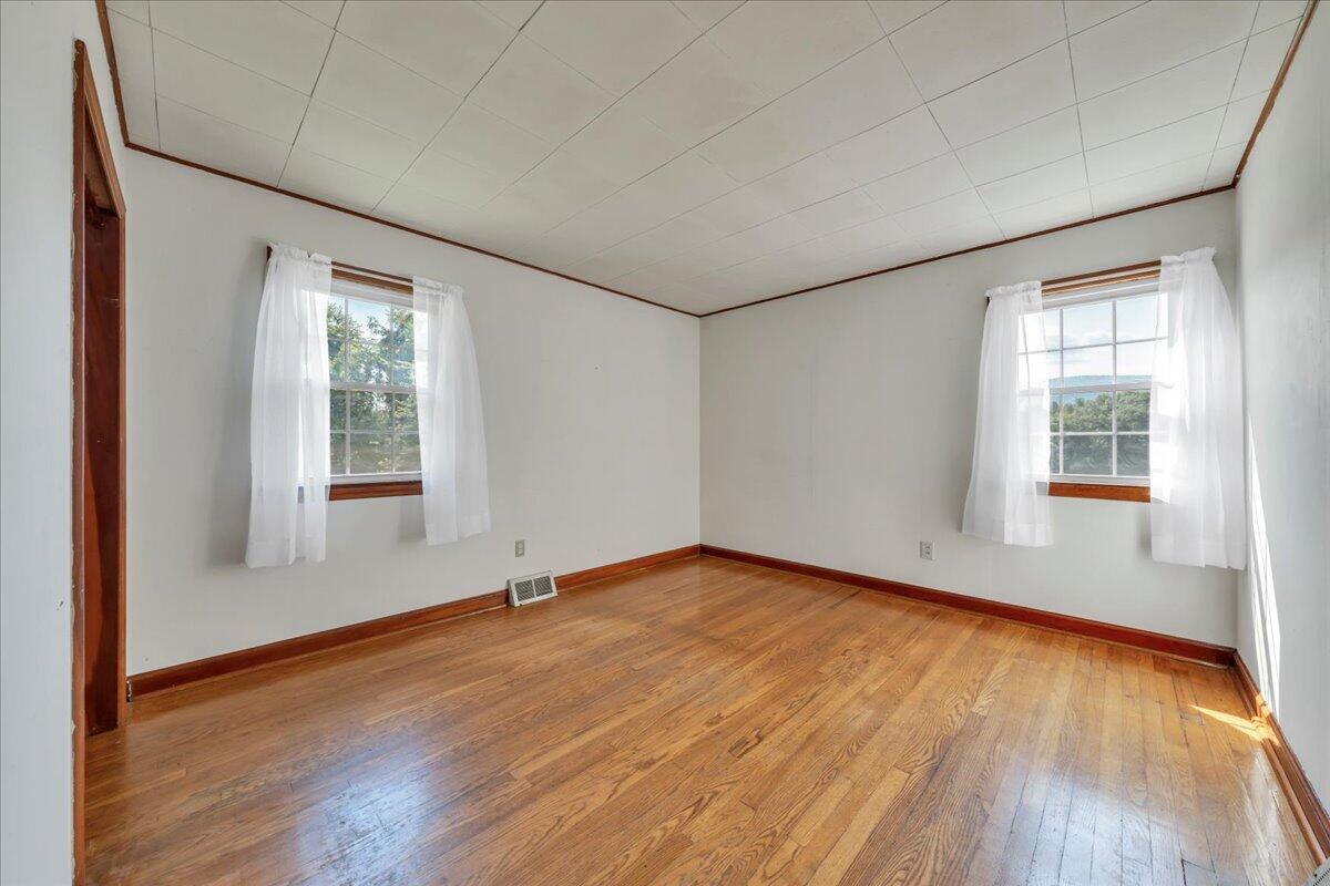 201 Long Avenue Covington, VA 24426 - Photo 14 of 43 an empty room with wooden floor and windows