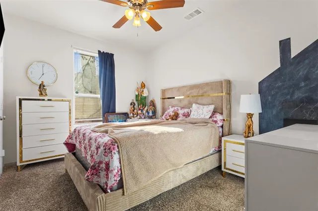 a bedroom with a bed and chandelier