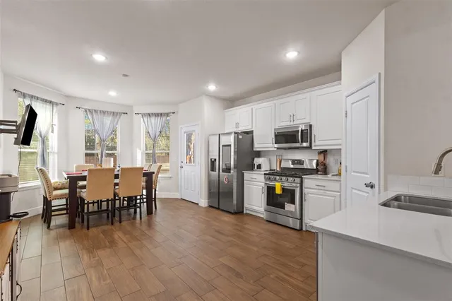 a view of a dining room with furniture kitchen and wooden floor