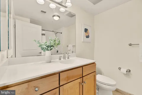a bathroom with a sink a toilet and mirror