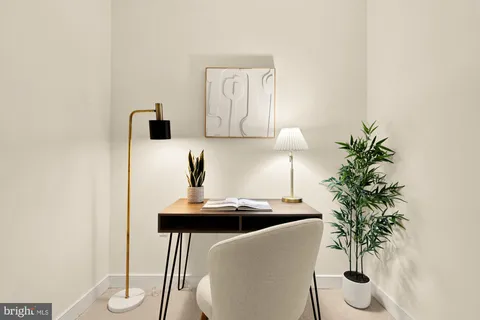 a living room with furniture and potted plant