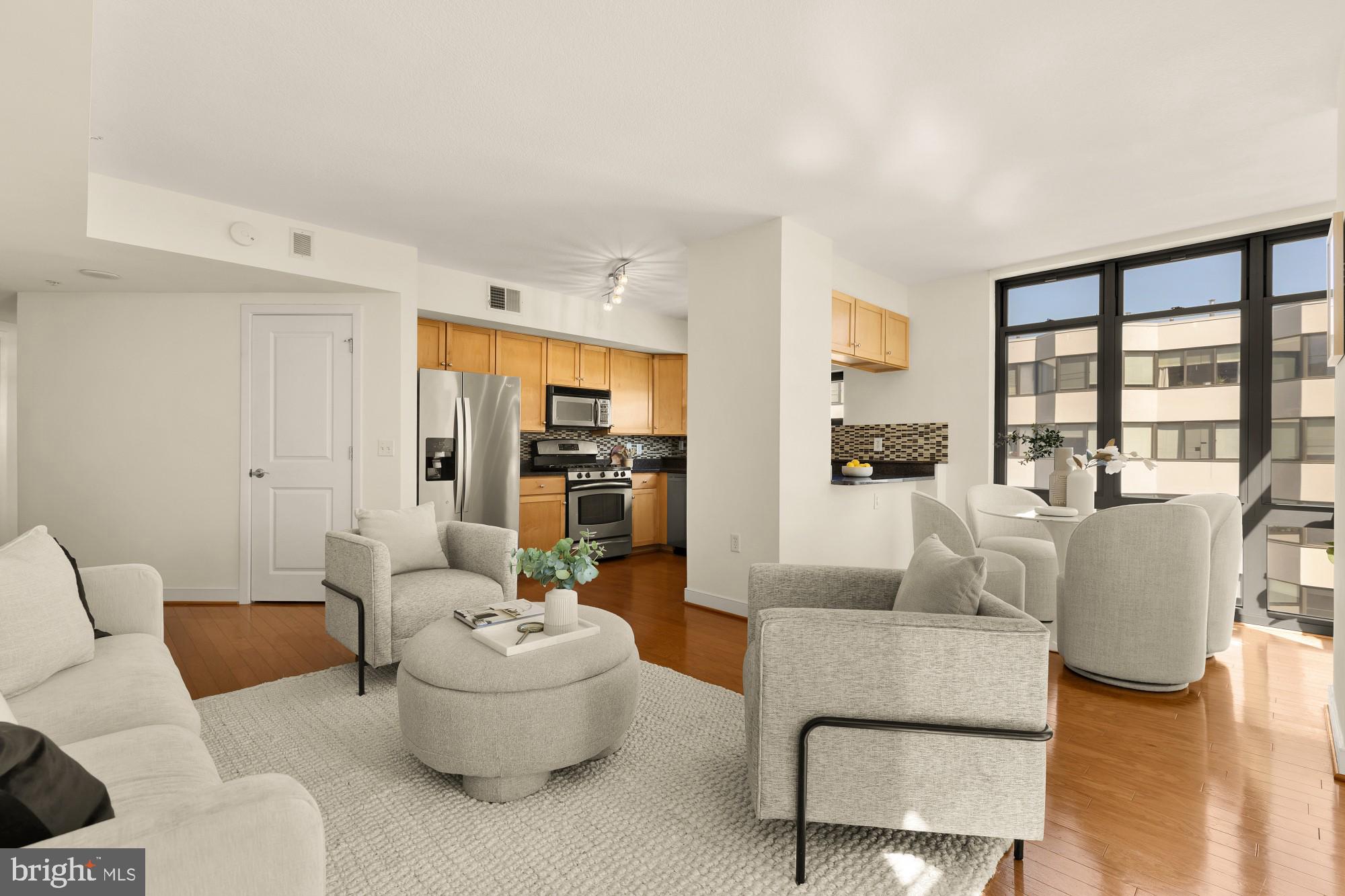 1117 10th Street Northwest, Unit 908 Washington, DC 20001 - Photo 2 of 19 a living room with furniture and a large window