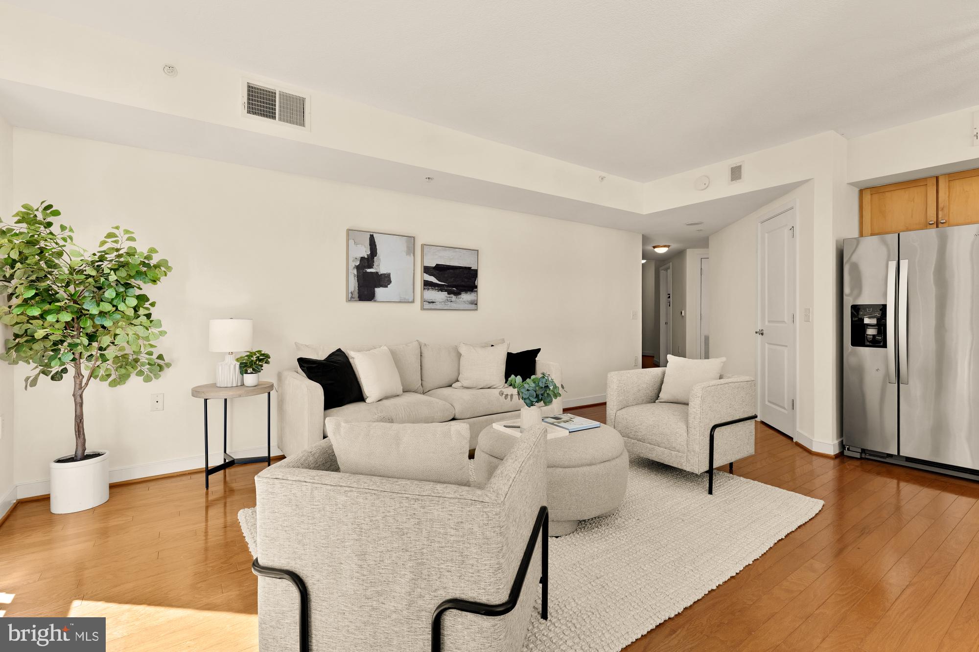 1117 10th Street Northwest, Unit 908 Washington, DC 20001 - Photo 5 of 19 a living room with furniture and a wooden floor