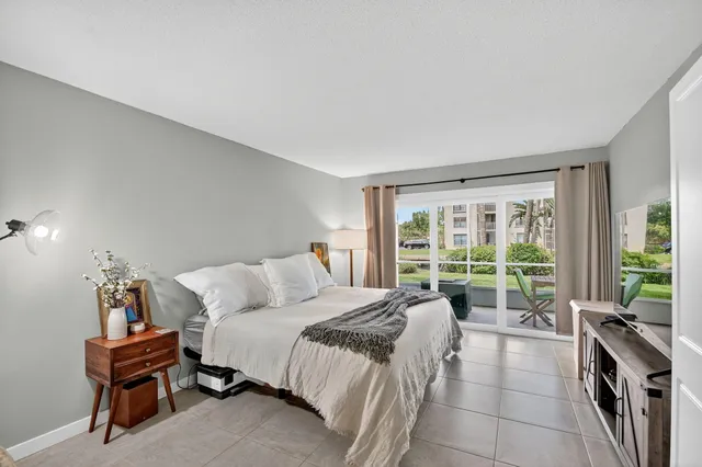 a bedroom with a bed and a lamp