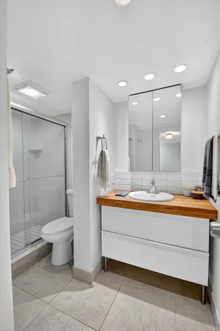 a bathroom with a toilet sink and mirror