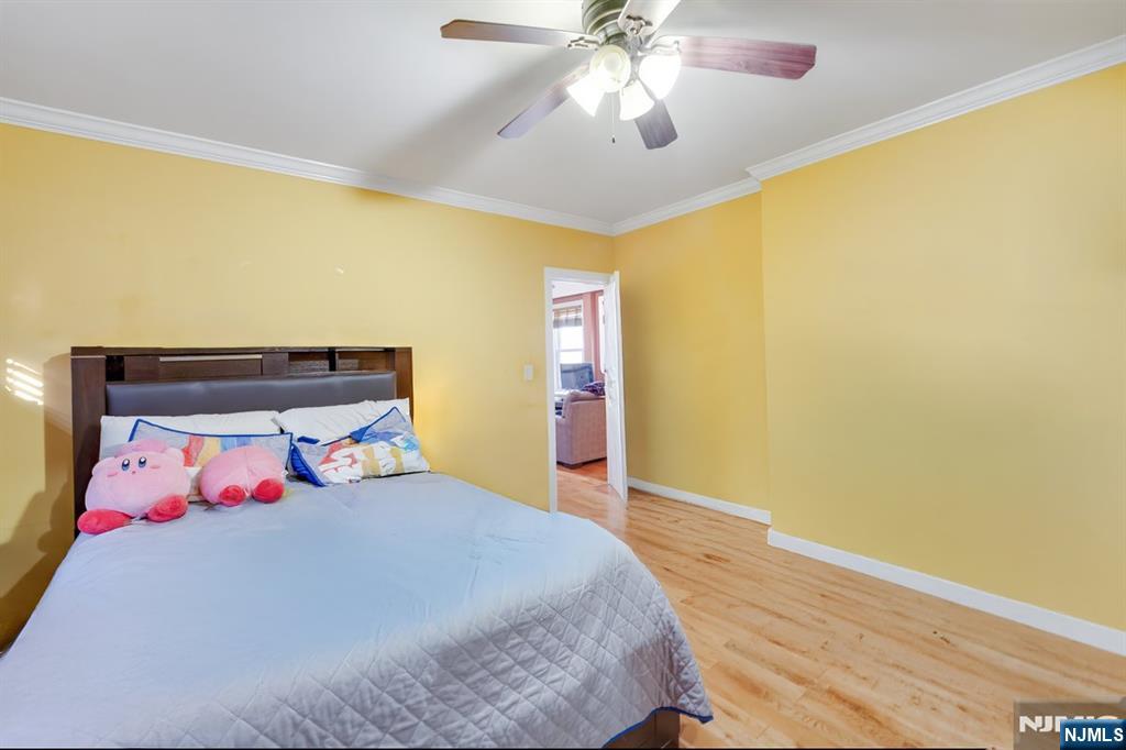 418 Taylor Avenue Hackensack, NJ 07601 - Photo 13 of 48 a bedroom with a bed and a chandelier