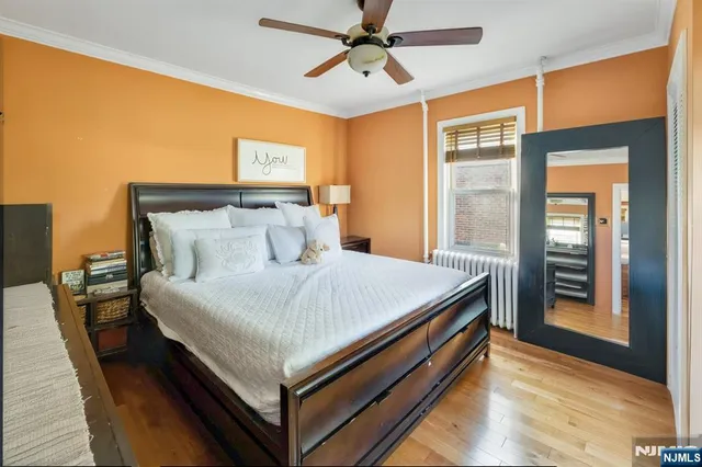 a bed sitting in a bedroom next to a window