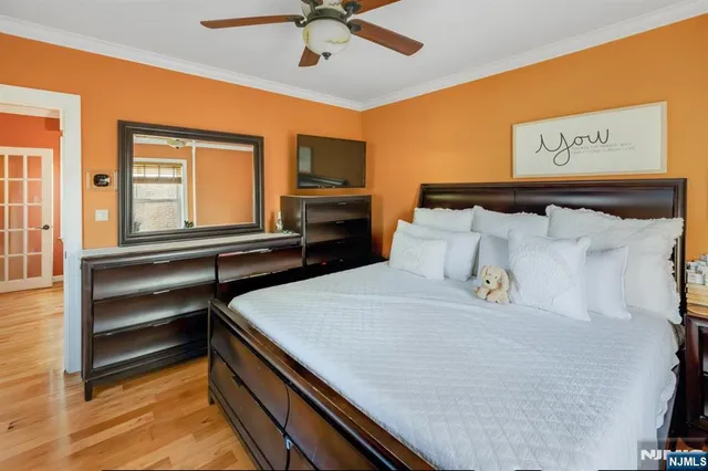 a bedroom with a bed and a flat tv screen