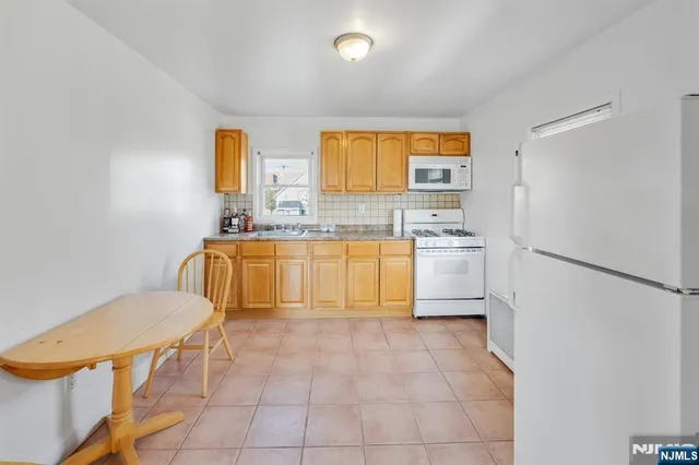 a kitchen with a sink cabinets and a refrigerator