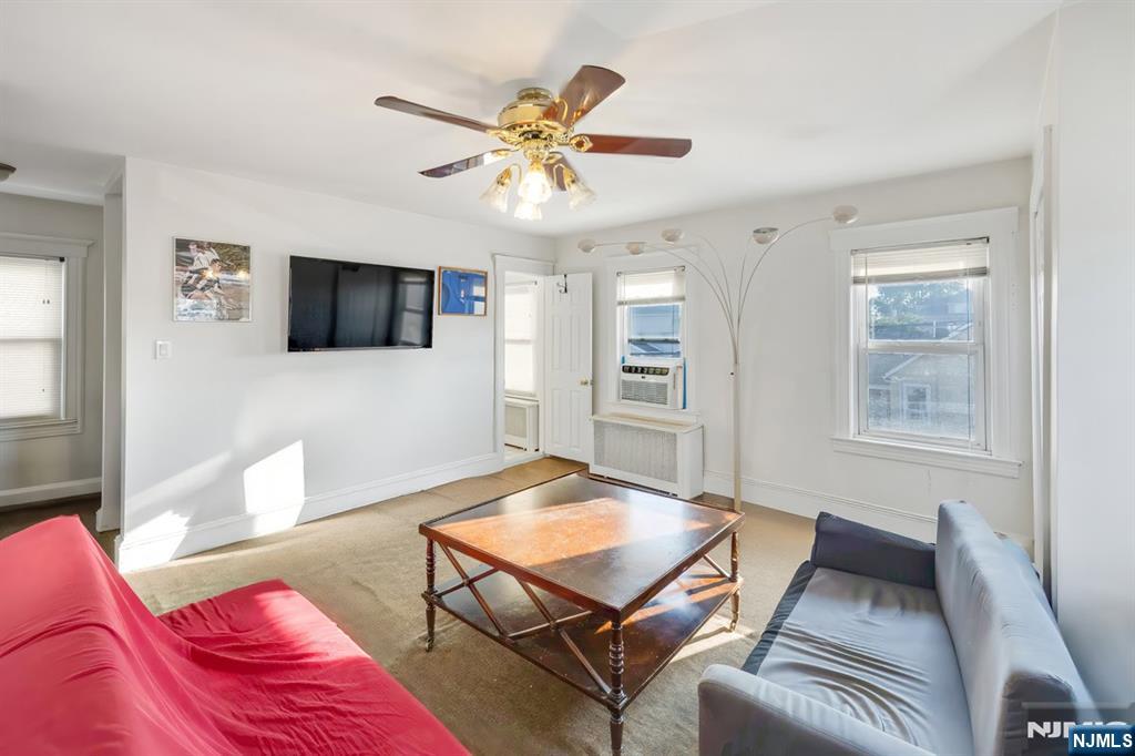 418 Taylor Avenue Hackensack, NJ 07601 - Photo 25 of 48 a living room with furniture and a flat screen tv