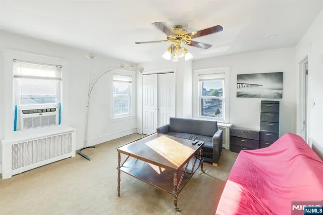 a white toilet sitting next to a bathroom sink and vanity