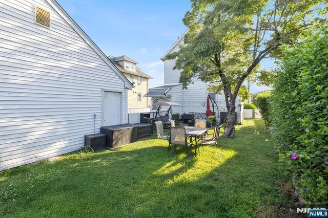 a view of a house with a backyard and a patio