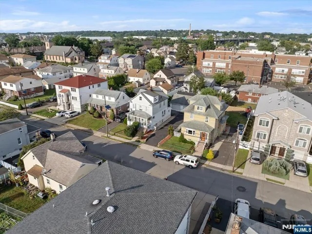 an aerial view of residential houses with city view