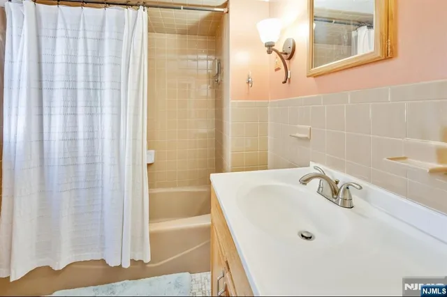 a bathroom with a tub and a sink