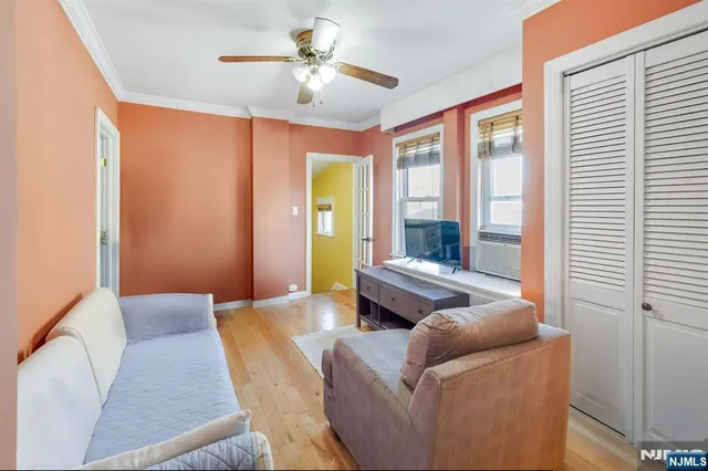 a bedroom with furniture and large windows