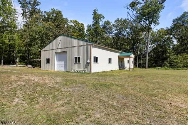 a view of a white house with a yard