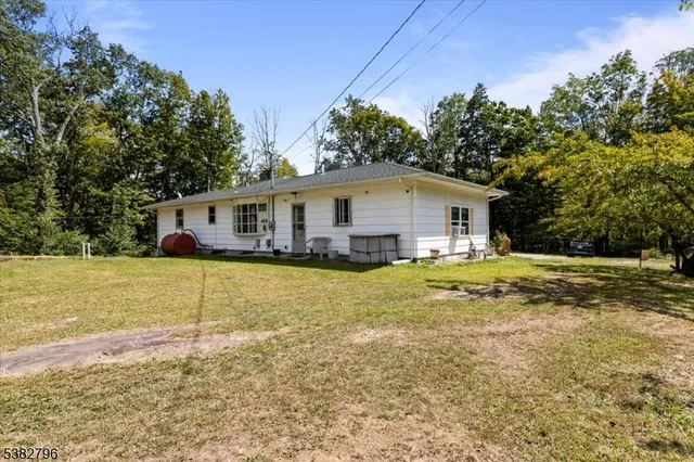 a view of house with outdoor space and swimming pool