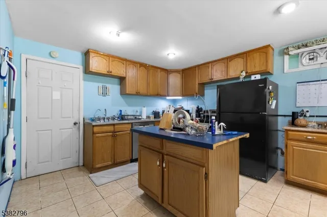 a kitchen with stainless steel appliances granite countertop a refrigerator stove and sink