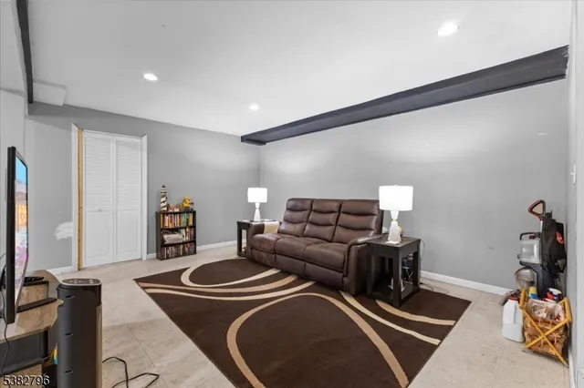 a living room with furniture a rug and a flat screen tv