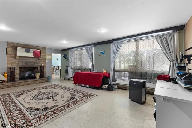 a living room with furniture rug and a fireplace