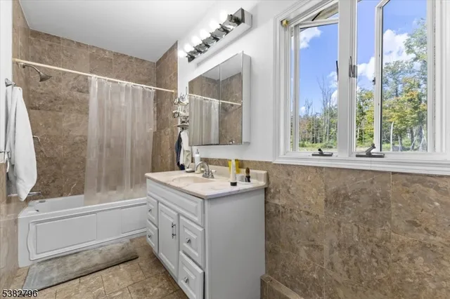 a bathroom with a sink a mirror and a shower