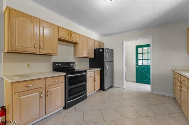 a kitchen with stainless steel appliances granite countertop a stove a refrigerator and a sink