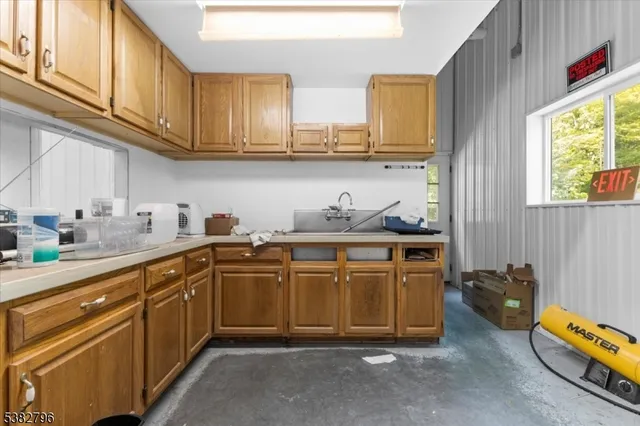 a kitchen with stainless steel appliances granite countertop a sink dishwasher stove and cabinets