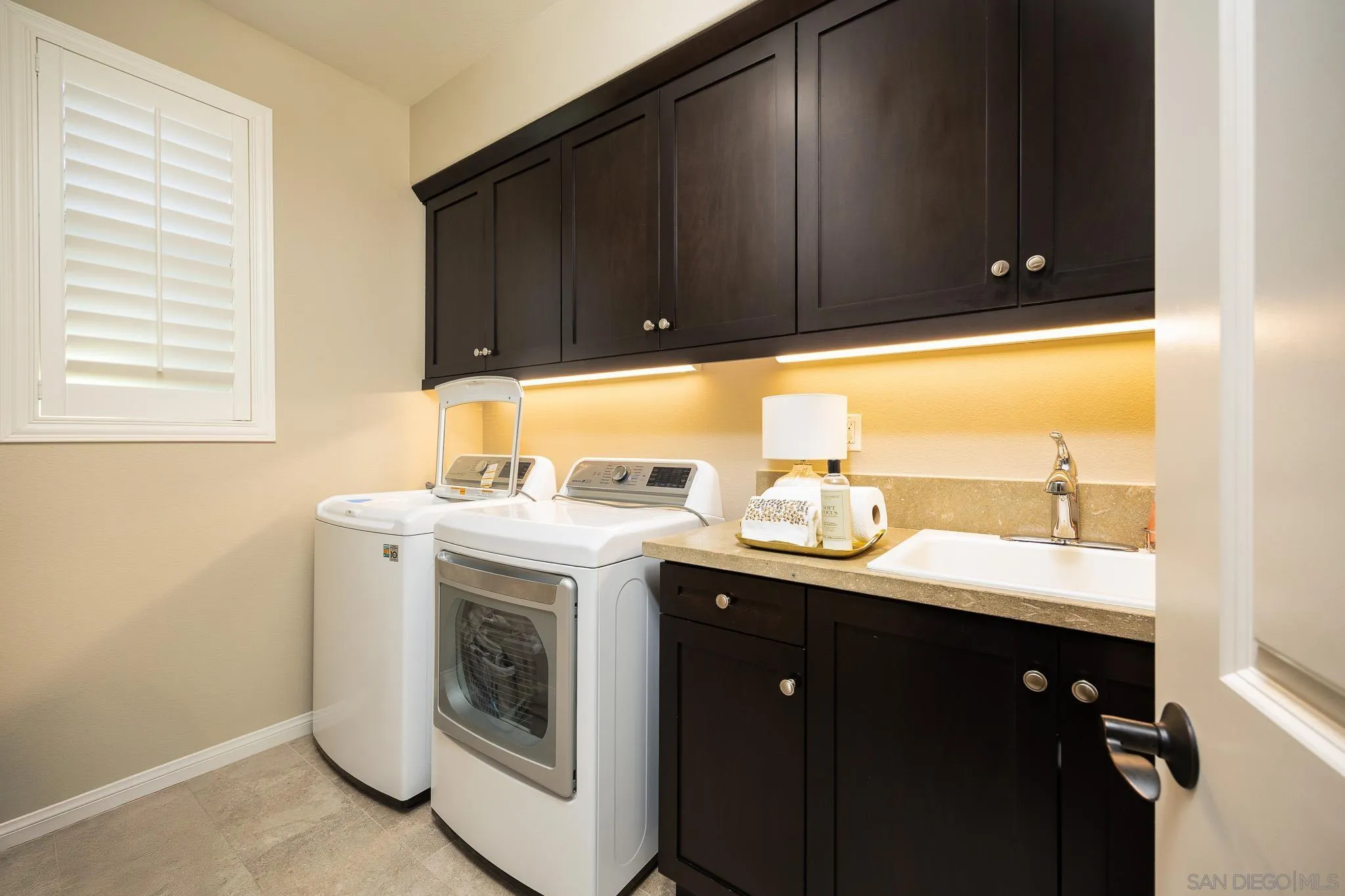 8112 Auberge Circle San Diego, CA 92127 - Photo 18 of 45 a utility room with sink dryer and washer