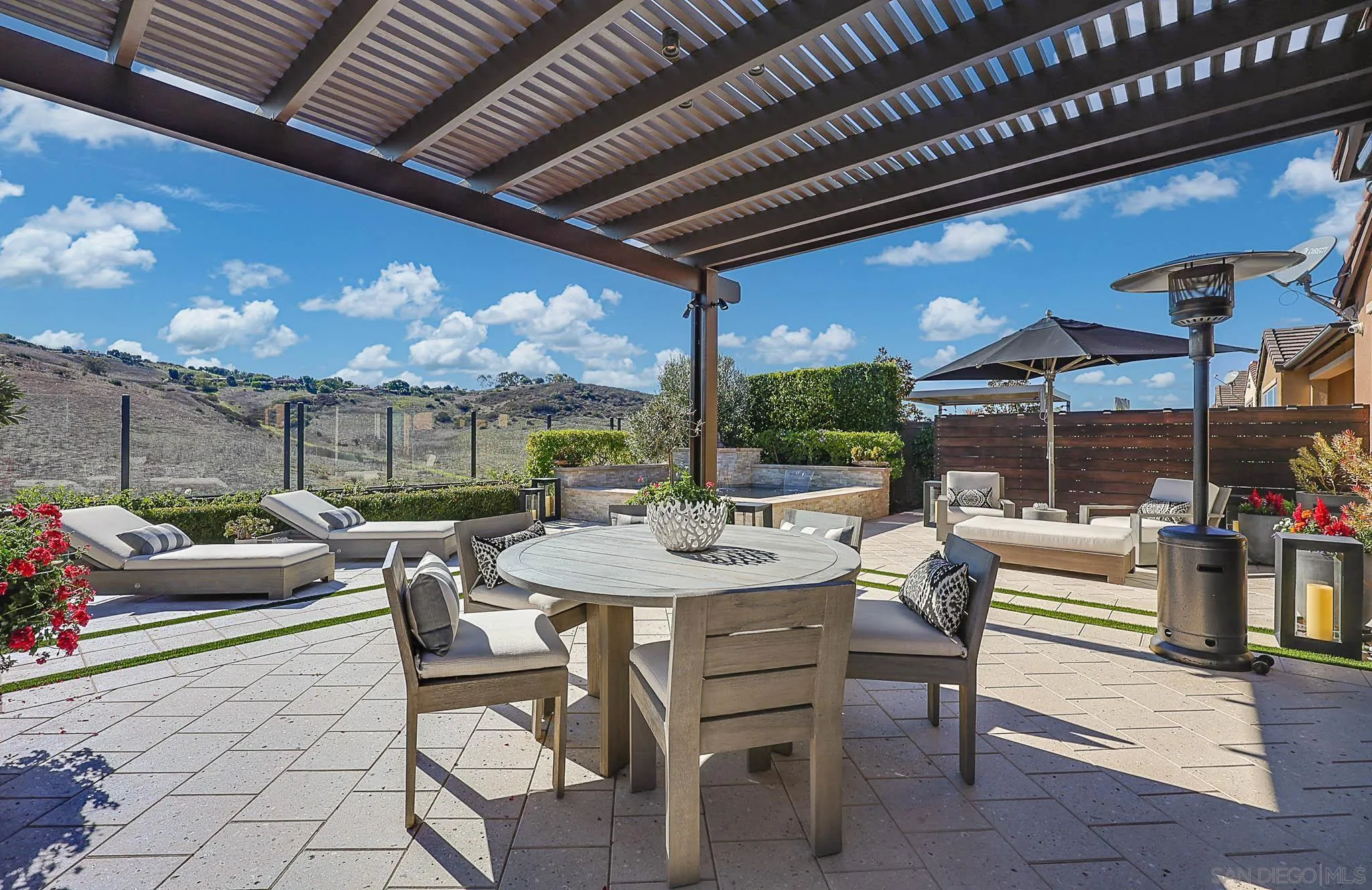 8112 Auberge Circle San Diego, CA 92127 - Photo 25 of 45 a view of a patio with a dining table and chairs with a barbeque