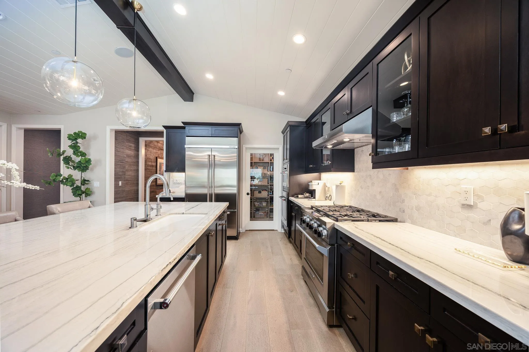 8112 Auberge Circle San Diego, CA 92127 - Photo 4 of 45 a kitchen with stainless steel appliances a sink stove and cabinets