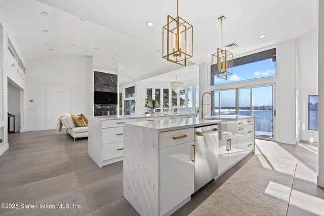 a kitchen with white cabinets and appliances