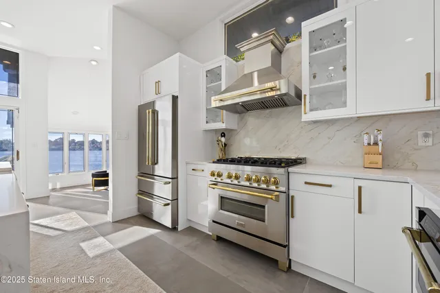 a kitchen with stainless steel appliances a stove a refrigerator and cabinets