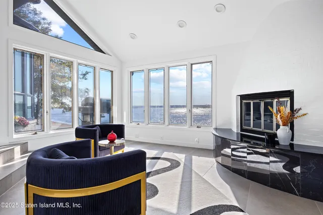 a living room with furniture and floor to ceiling windows