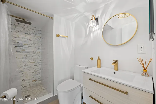 a bathroom with a sink a toilet and a mirror